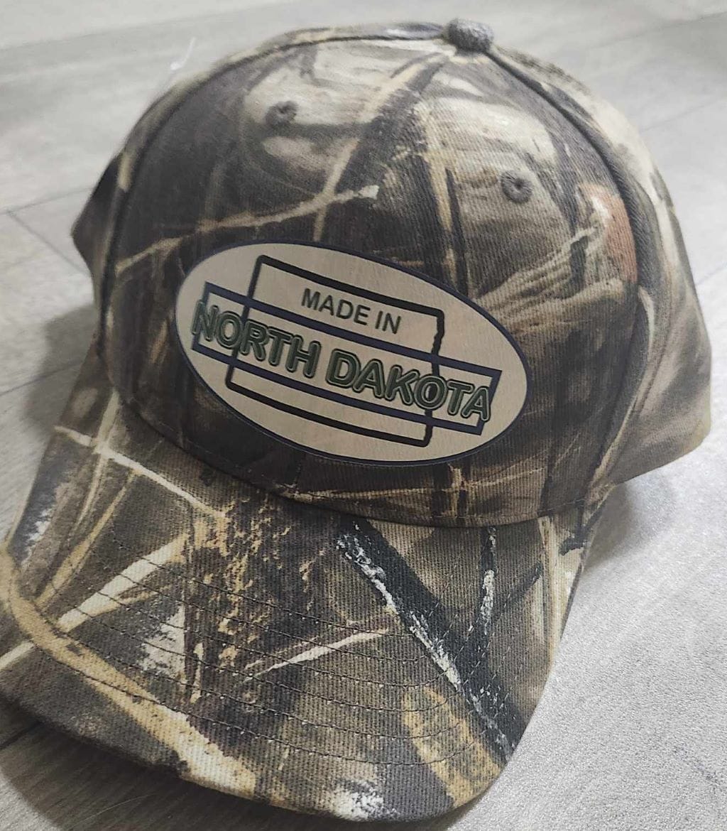 Oval Version of Made in North Dakota on a Camouflage Cap - Image 13