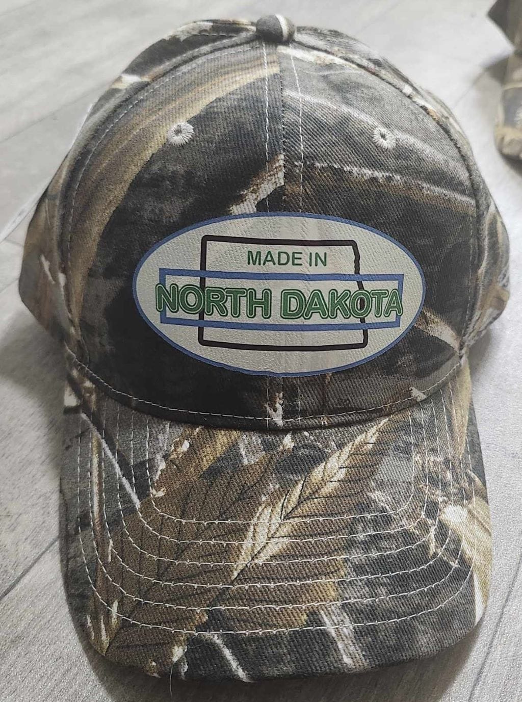Oval Version of Made in North Dakota on a Camouflage Cap - Image 23