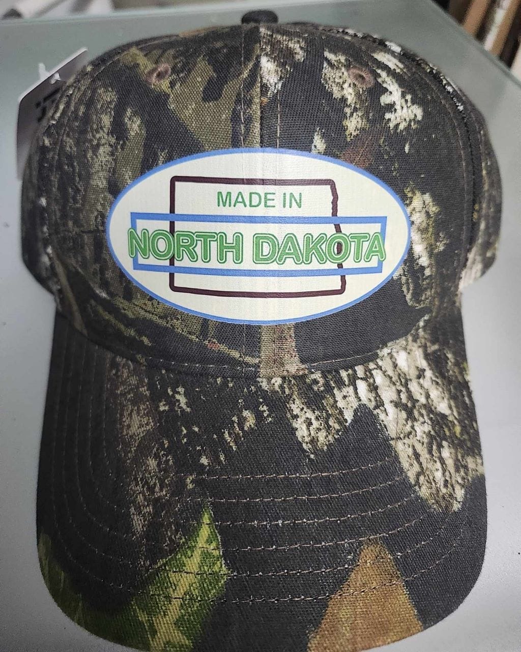 Oval Version of Made in North Dakota on a Camouflage Cap - Image 21