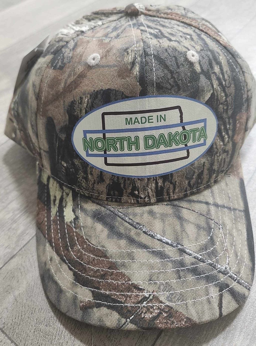 Oval Version of Made in North Dakota on a Camouflage Cap - Image 19