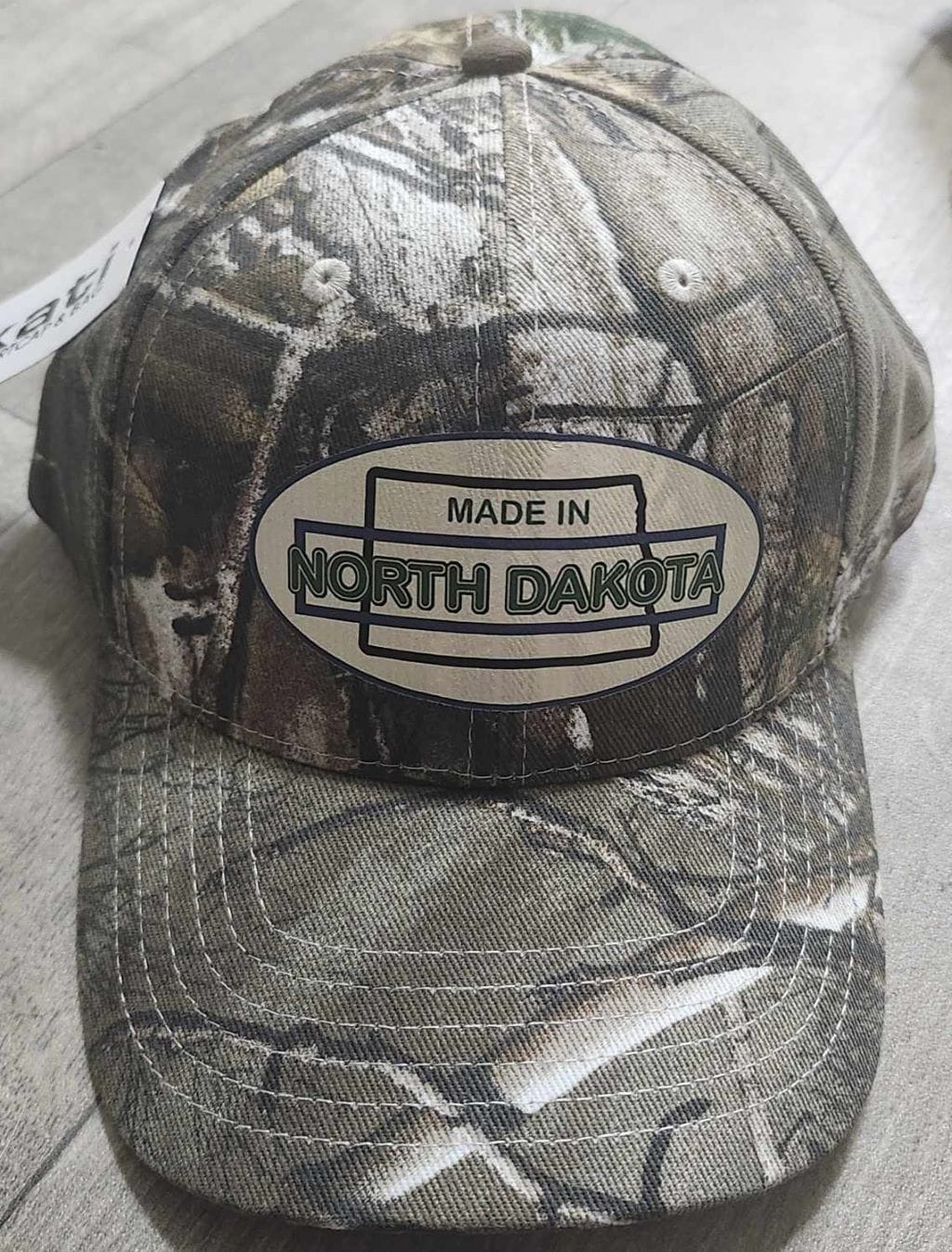 Oval Version of Made in North Dakota on a Camouflage Cap - Image 15