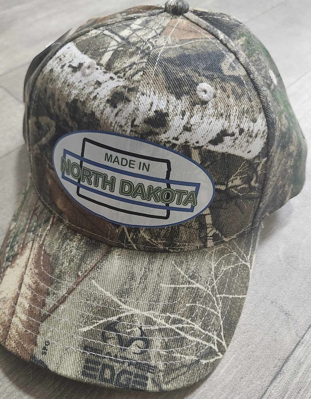 Oval Version of Made in North Dakota on a Camouflage Cap - Image 11
