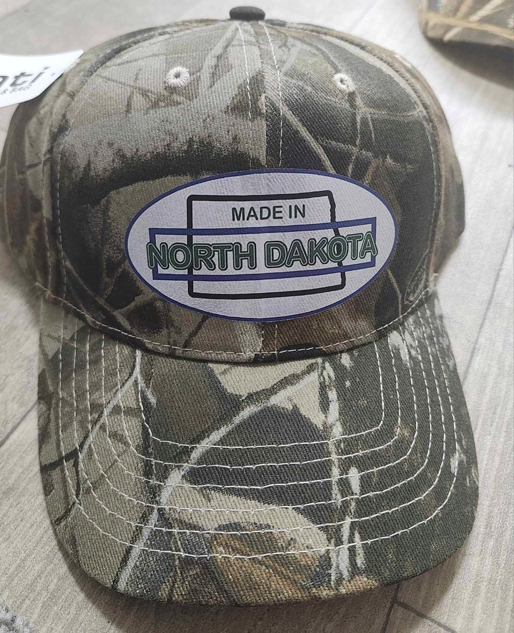 Oval Version of Made in North Dakota on a Camouflage Cap - Image 8