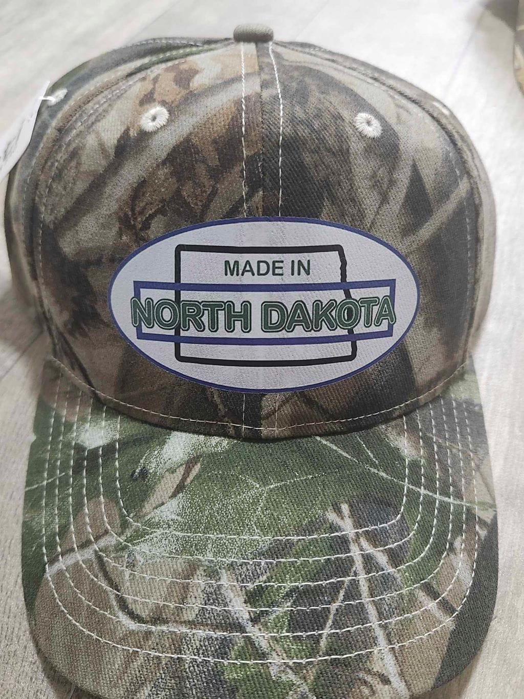 Oval Version of Made in North Dakota on a Camouflage Cap