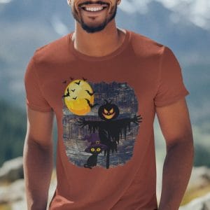 Scarecrow and Cat wearing a Witch Hat on a Fall Day on a CVC T-Shirt